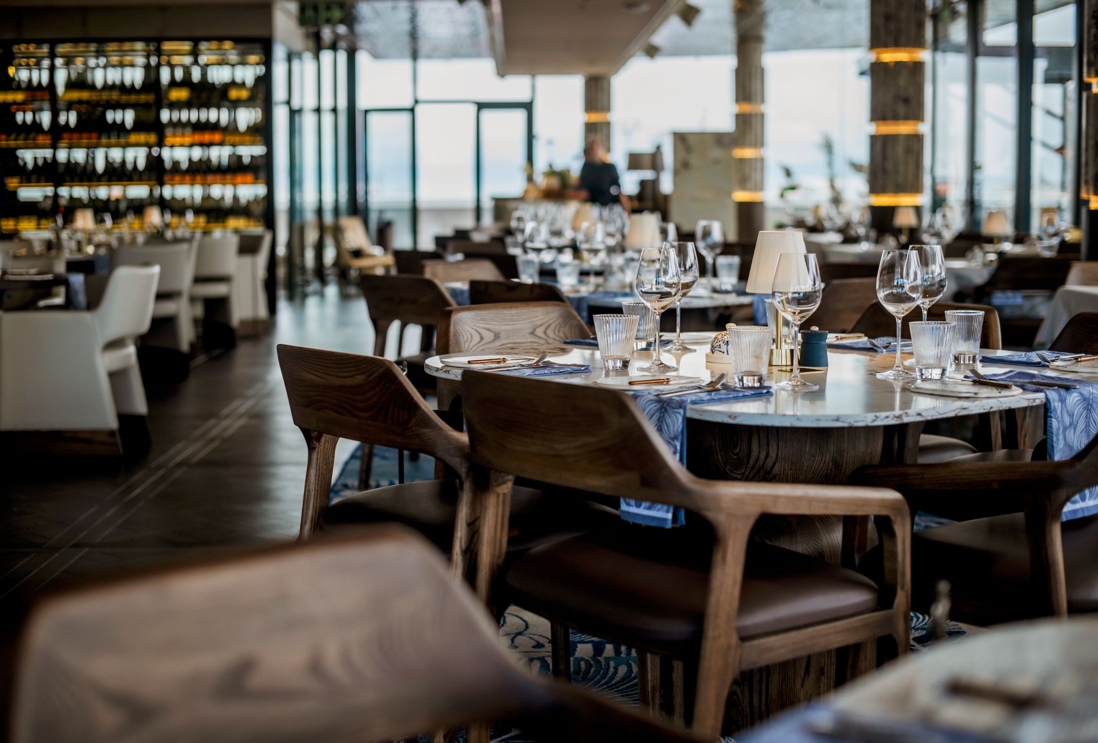 V&A Waterfront dining restaurant interior with elegant marble tables and wine cellar display